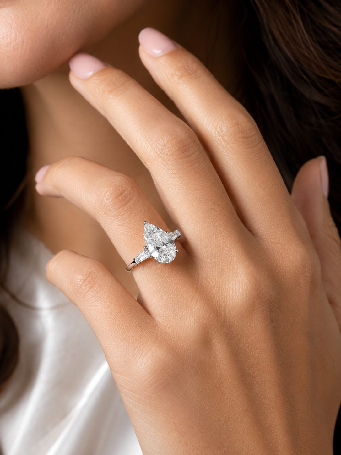 Pear-cut diamond ring worn on the hand