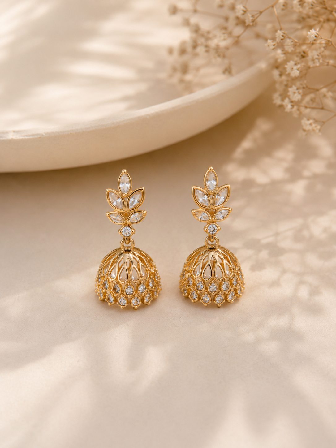 Gold jhumkas with white stones