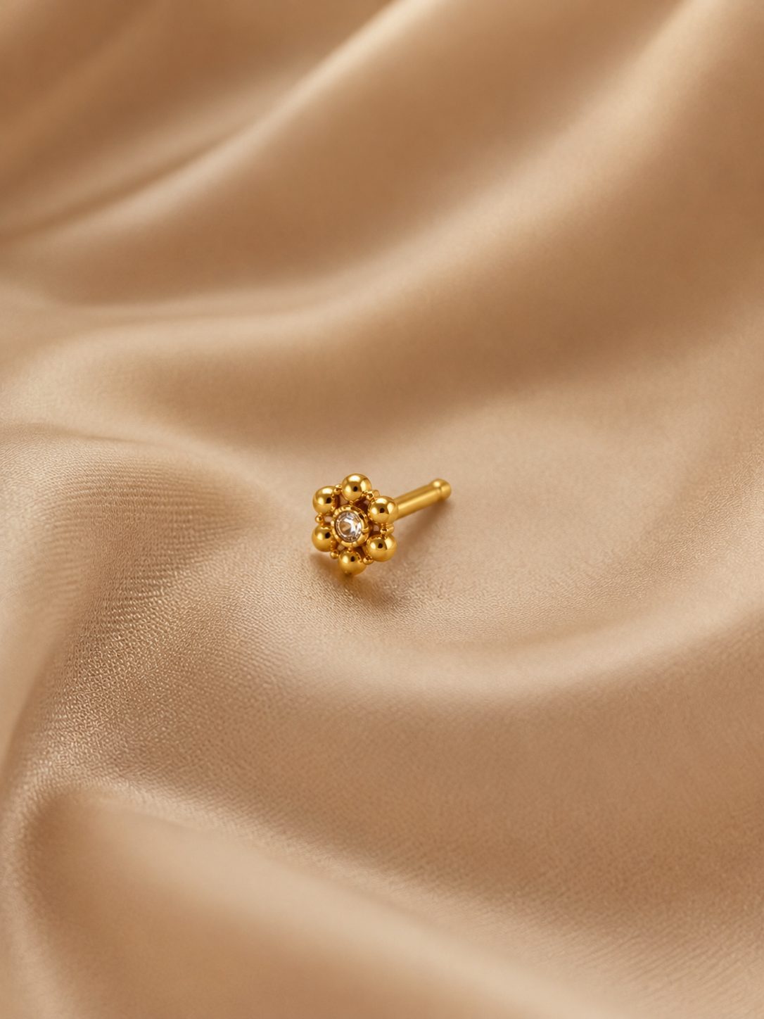 Gold flower mookuthi close-up