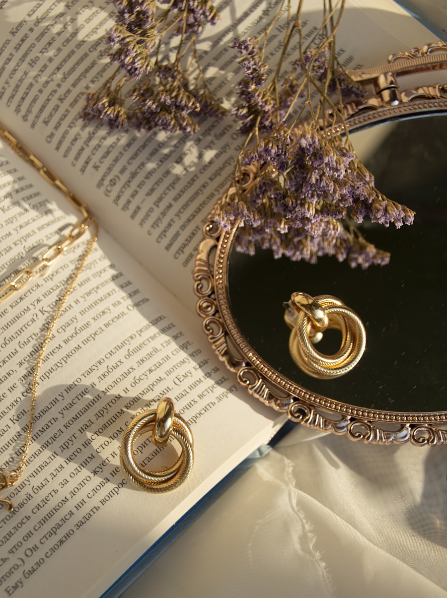 Solid gold earrings and chain arranged on an ornate mirror